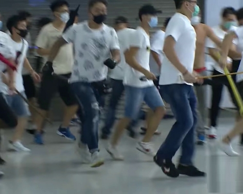 去年7月21日有白衣人在西鐵元朗站手持武器追打途人。港台截圖