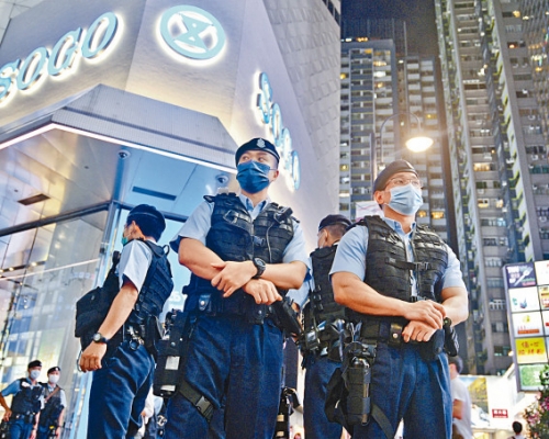 身穿戰術背心的警員昨晚在銅鑼灣一帶戒備，氣氛凝重。 蘇正謙攝