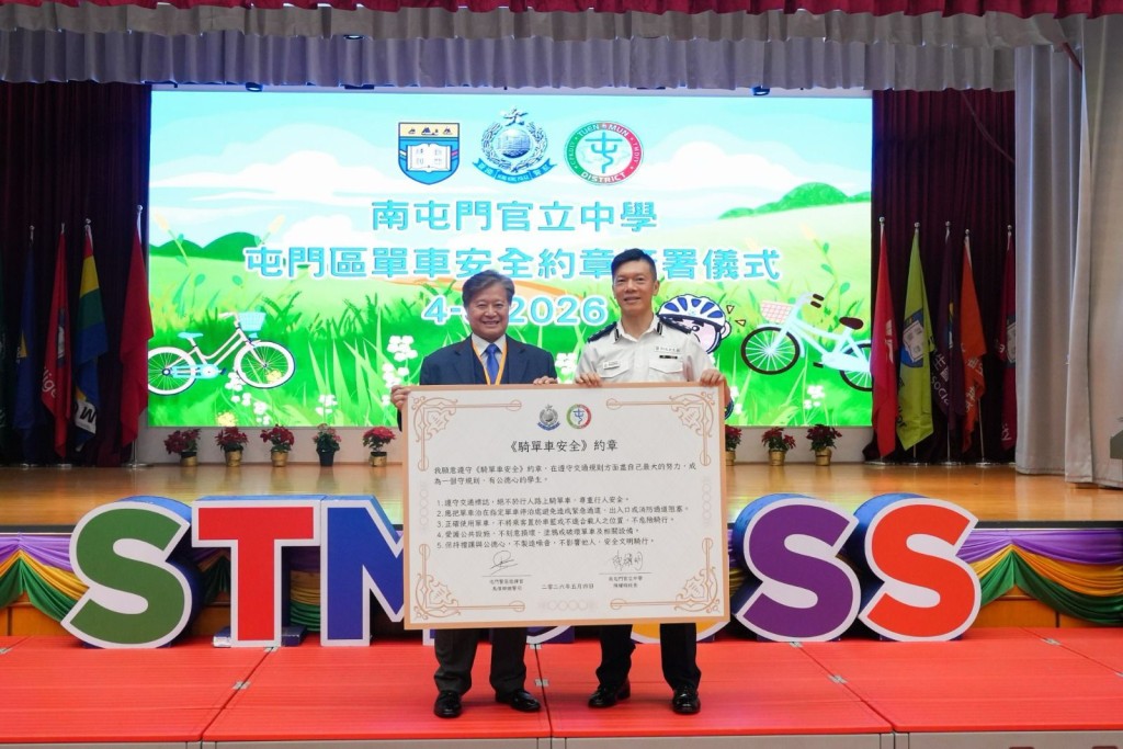 馬偉卿總警司頒發單車安全約章予南屯門官立中學陳耀明校長。