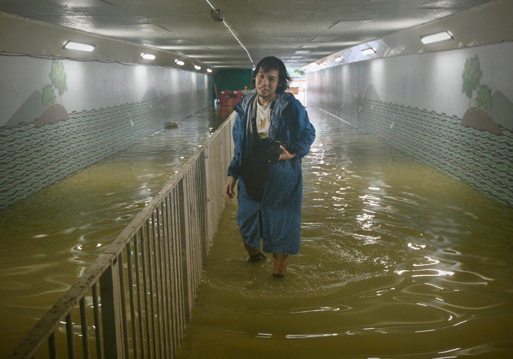 沙田城门河附近隧道水浸，巿民涉水而行。苏正谦摄