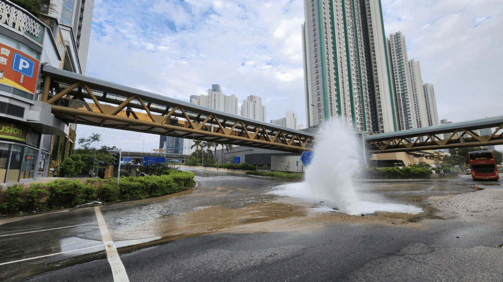 地下喷出的水柱水流极猛，很快已淹没附近路面。黎志伟摄