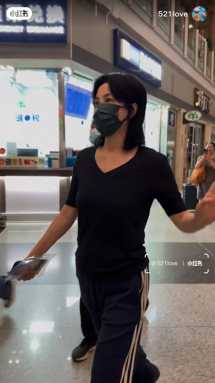 王菲简单穿上黑色T恤配蓝色条纹运动裤，加上同品牌的波鞋，被网民指气质打扮似谢霆锋。