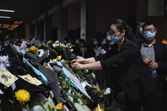 來自全國各地的民眾有序排隊獻上鮮花，追思袁老。