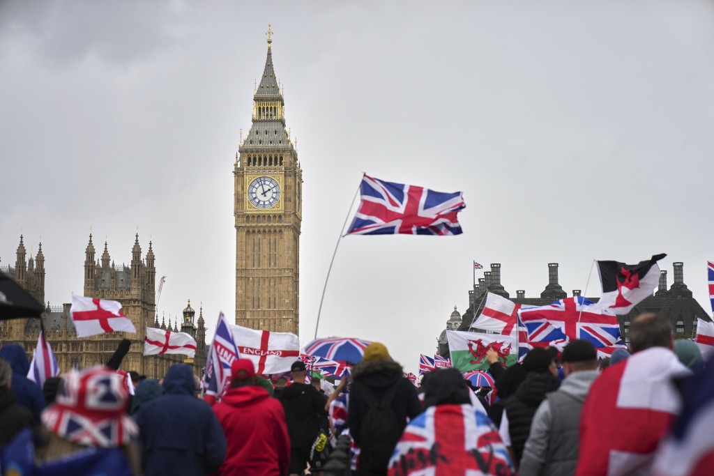 示威者高舉英國米字旗及英格蘭聖喬治十字旗。美聯社