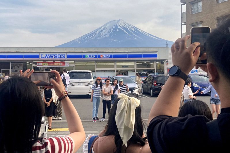 山梨县富士河口湖町的LAWSON便利店成为拍摄富士山热点后，当地町公所决定设置黑色布幕遮挡美景。路透社