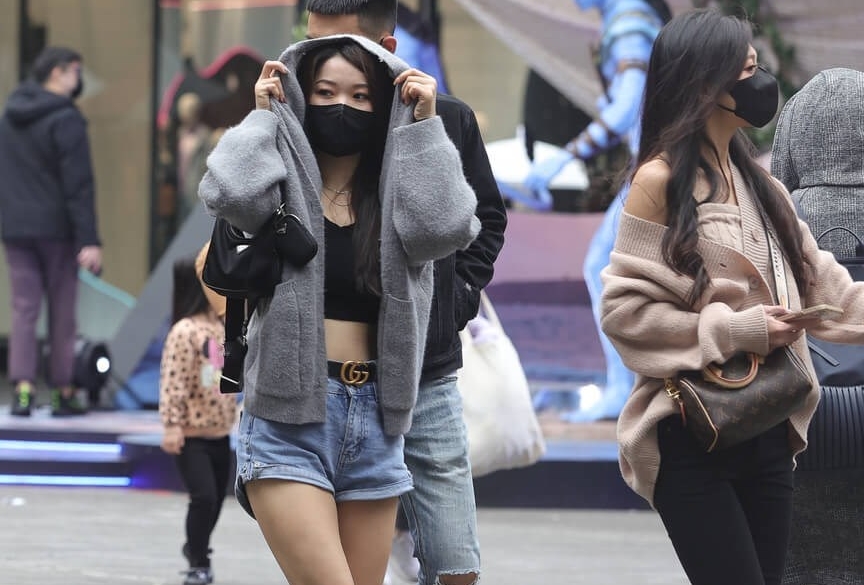 寒流抵台,街上行人穿多了衣服。