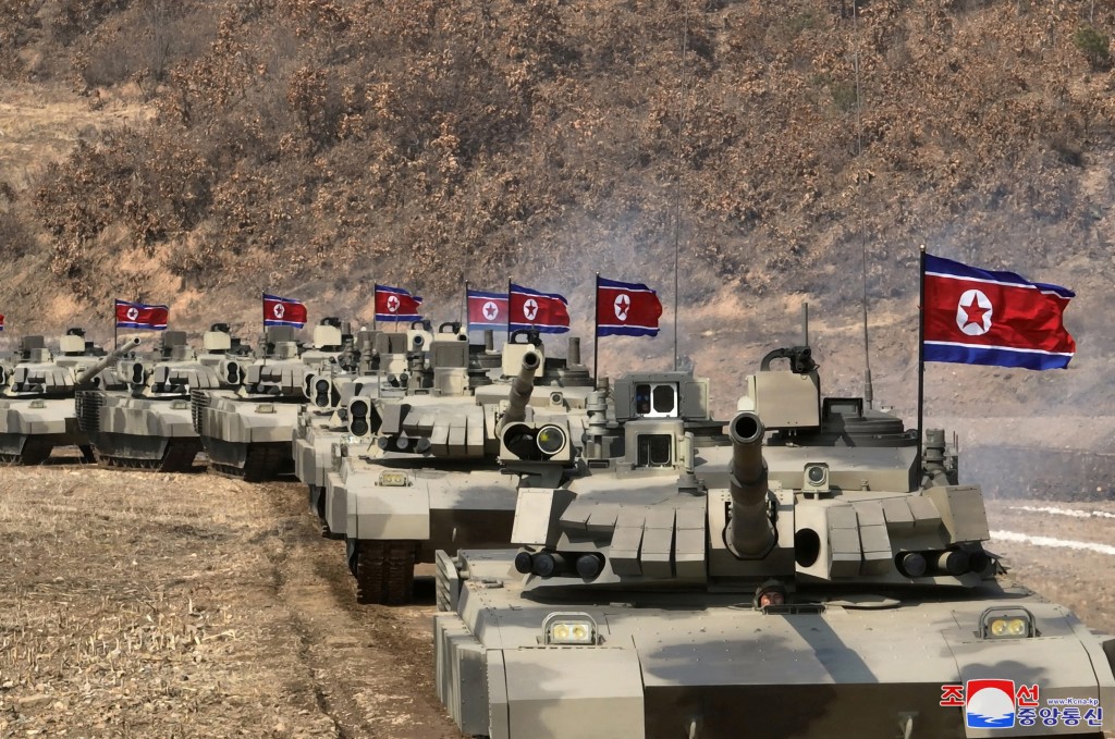 多辆车身插有北韩国旗的坦克在旷野发射实弹。路透社
