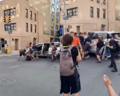 一批便衣人员在曼克顿市中心街上拘捕一名女子，强行把她推上车。网图