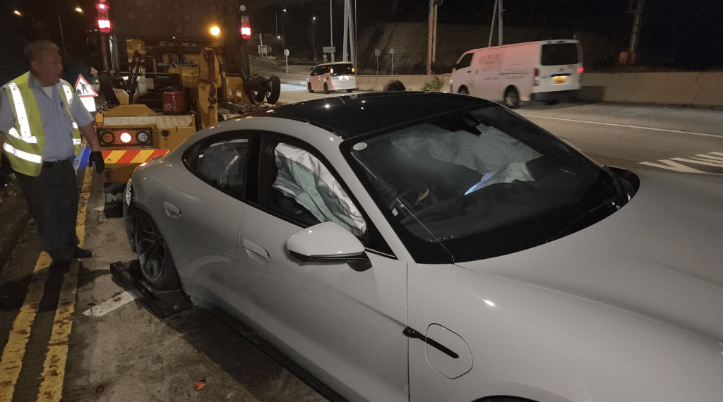 現場所見,保時捷被拖出管道外,車頭嚴重損毀,擋風玻璃碎裂,安全氣袋彈出。黎志偉攝 現場所見,保時捷被拖出管道外,車頭嚴重損毀,擋風玻璃碎裂,安全氣袋彈出。黎志偉攝