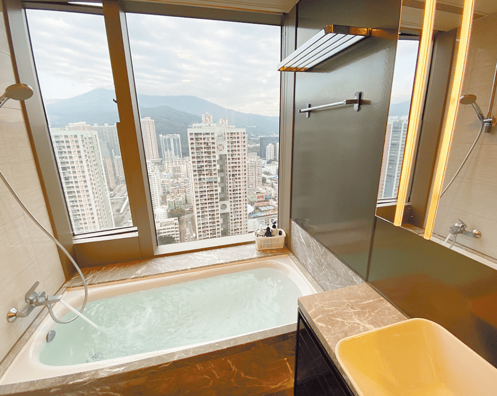 浴室设有浴缸设备，旁边设有大玻璃，可饱览荃湾市景。