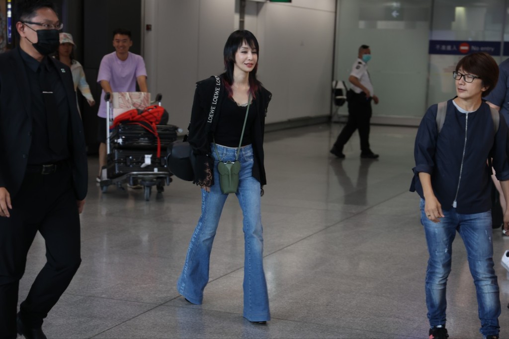 中島美嘉身穿牛仔褲與黑色低胸上衣。