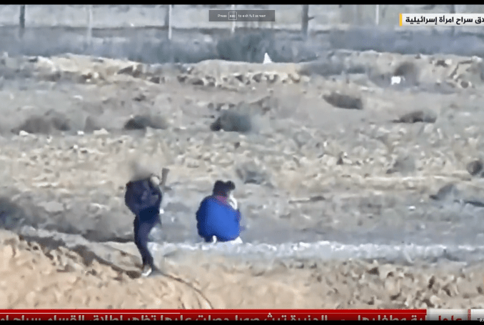 1名身穿蓝色上衣的女子和2名孩童在一处架设有刺铁丝网的地区出现后，有武装分子离去。网上图片 