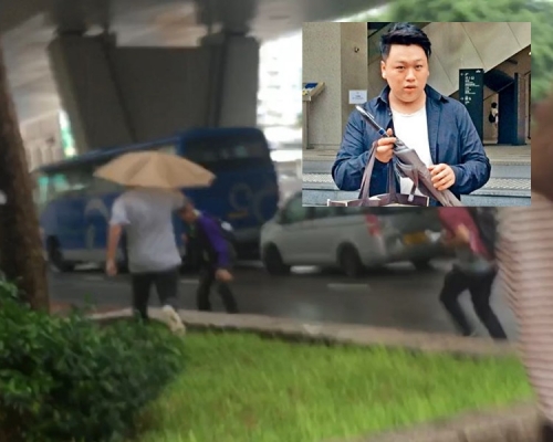 被告陳裕恆(持傘者)。梁銘姿攝