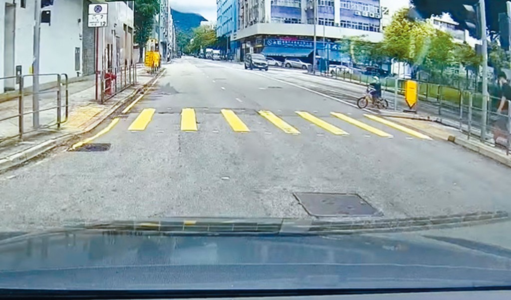 私家車駛近，男童騎單車衝出安全島。下圖為司機及時停車，未撞及單車童。