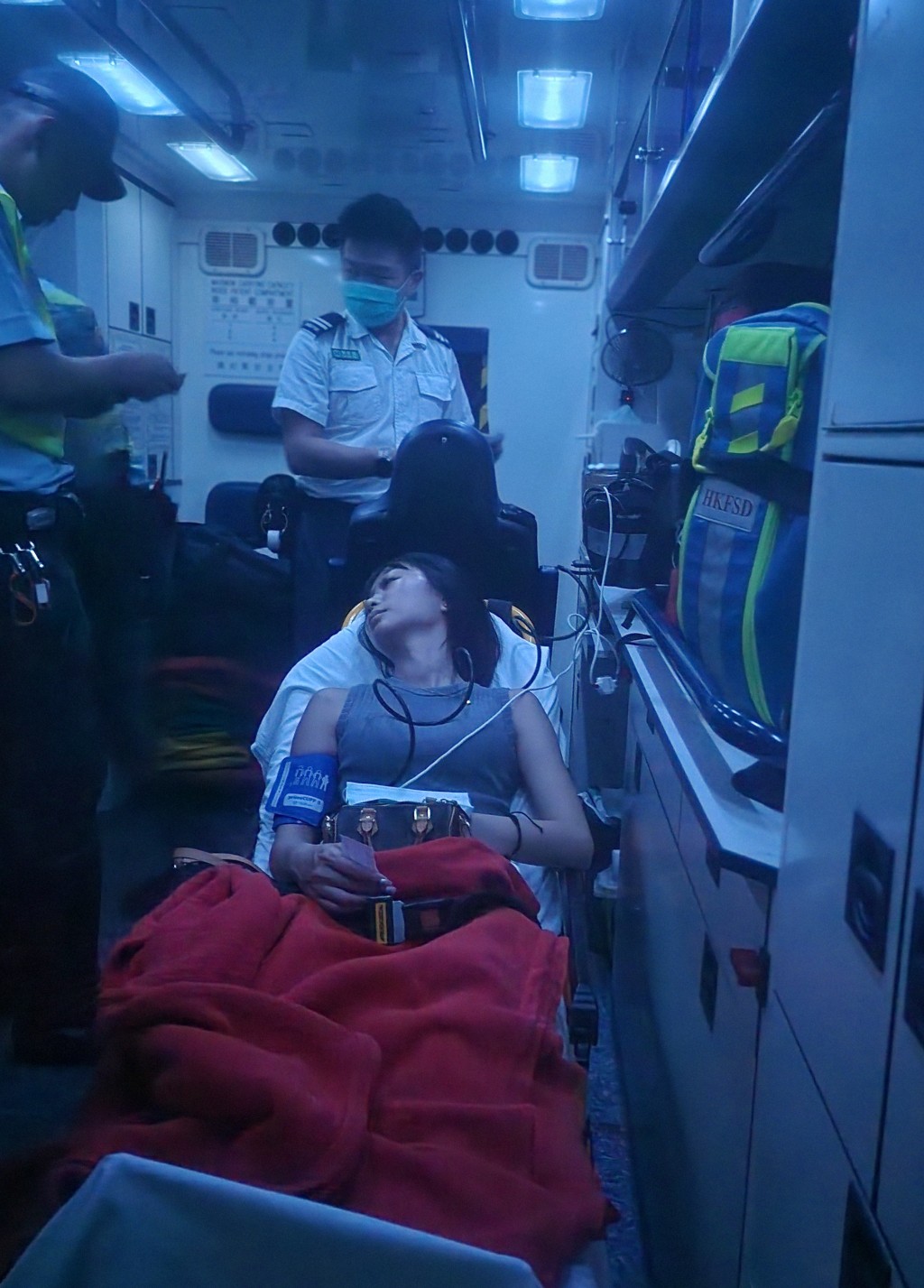 女乘客在救護車上接受治理。