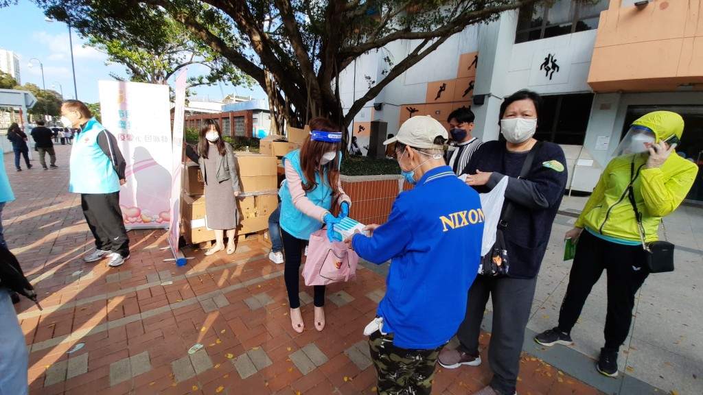 香港義工聯盟向每位接種疫苗的市民派贈內含5盒快測套裝的「抗疫愛心包」。