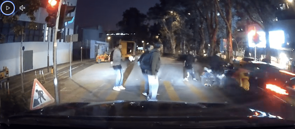 当自行车行至接近道路中央行人等候处时，一辆私家车突然高速冲出，将其猛力撞飞。