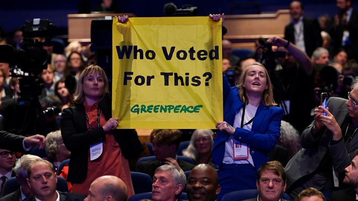 有綠色和平成員在保守黨年會上舉起標語，抗議卓慧思內閣不重視環保議題。路透社圖片