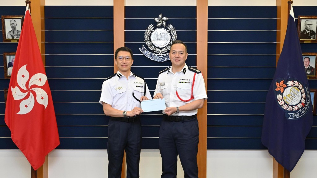警務處處長周一鳴(右)頒授委任狀予新委任香港輔助警察隊副總監林俊富(左)。政府新聞處圖片
