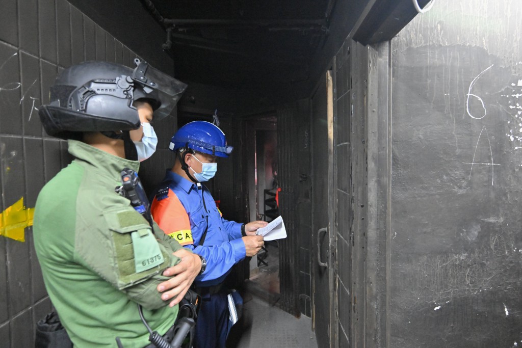 警務人員與民眾安全服務隊隊員駐守樓層，全力支援上樓居民。政府新聞處圖片
