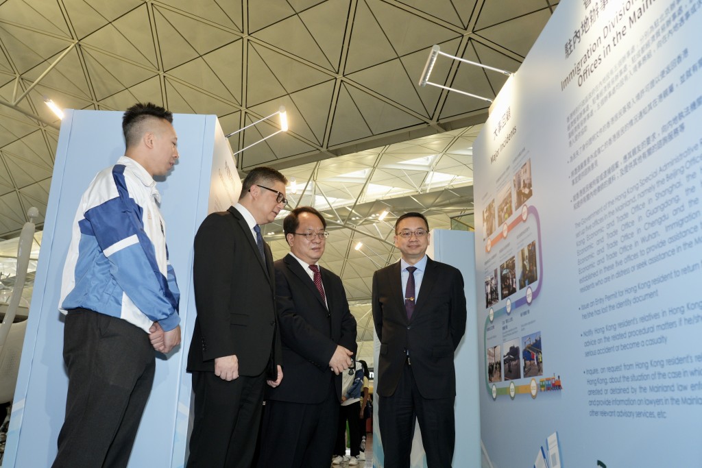 鄧炳強與潘雲東等一眾官員參觀「領事保護巡迴展覽」。歐樂年攝