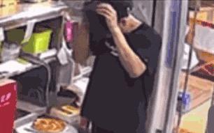 涉事男員工在製作時揭開工作帽並狂揉頭髮。中華網 涉事男員工在製作時揭開工作帽並狂揉頭髮。中華網