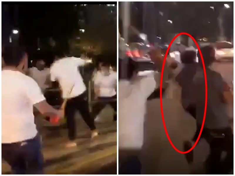 白衣人街頭追打某人。影片截圖