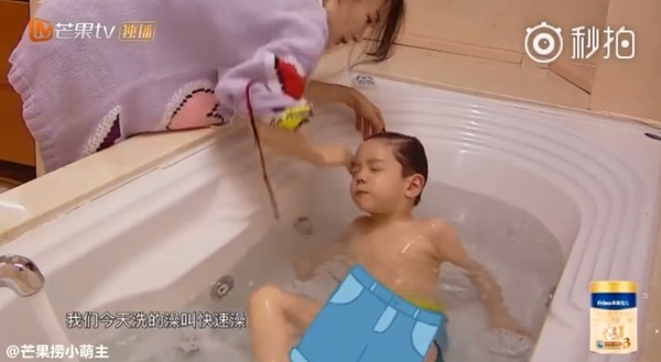 嗯哼让妈妈为他冲走肥皂泡，又躺在浴缸任妈妈冲水，十分乖巧。