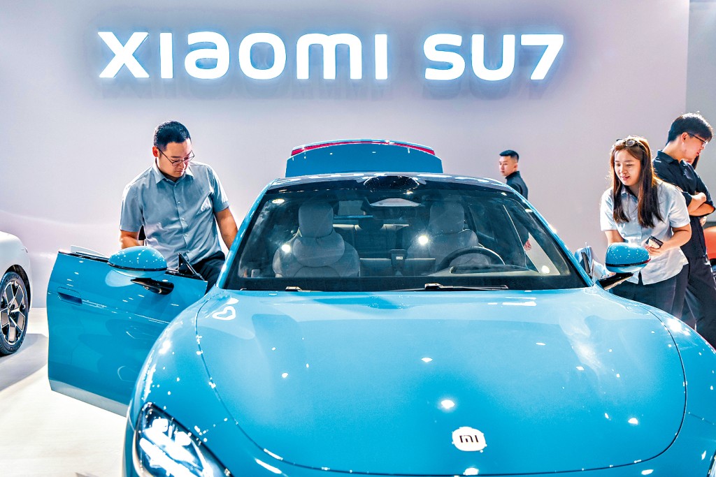 去年的海南車展上,小米SU7電動車吸引多人參觀。 去年的海南車展上,小米SU7電動車吸引多人參觀。