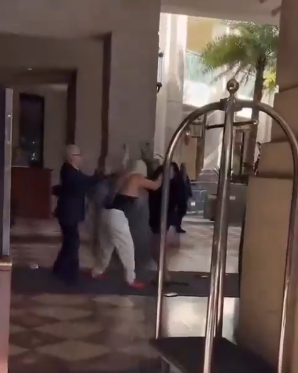 影片显示两名女子在酒店外拉扯，白裤tubetop女扯头发兼挥拳。