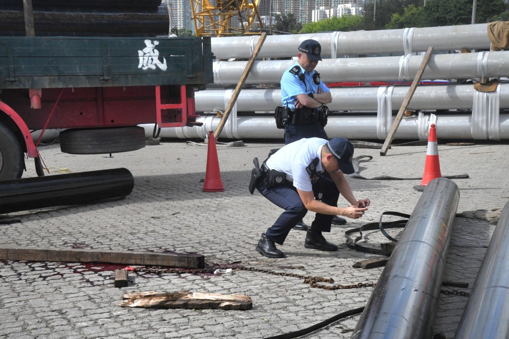 警員在場搜證，拍攝捆綁鐵管的鐵片帶。