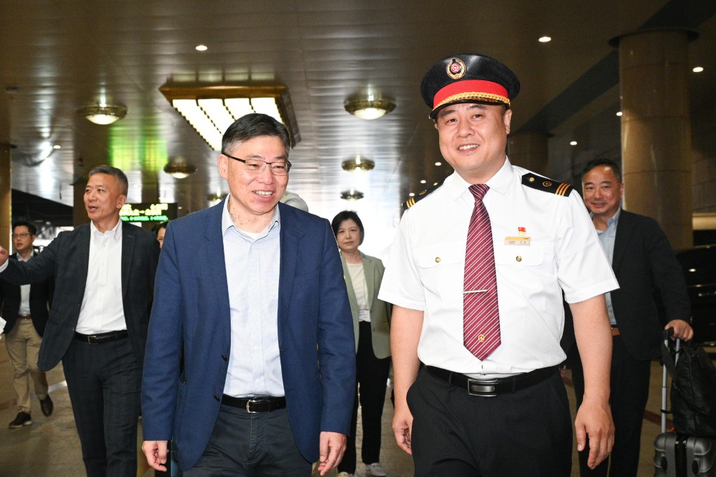 林世雄（左）与车务人员出席首发列车欢迎仪式。政府新闻处