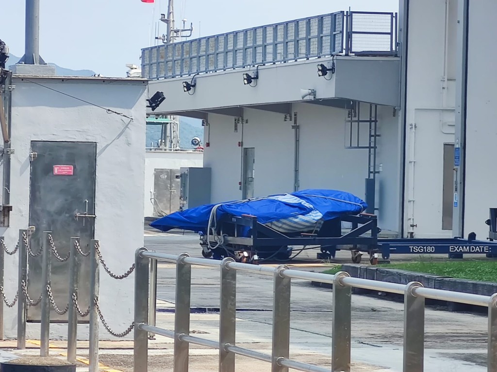 警員合力將碎片移上水警快艇，運到對面海水警基地，並以帆布包裹。