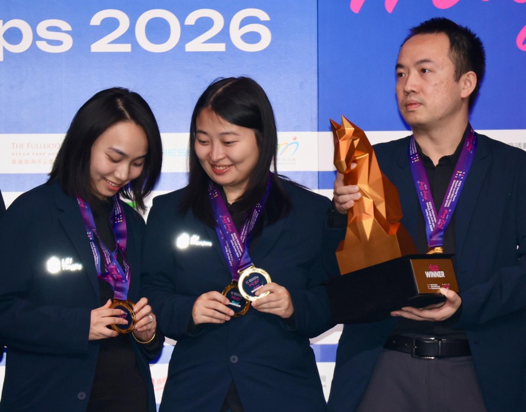 2位女將居文君（中）及雷挺婕（左），也忍不住要看清楚手上這2面意義重大的金牌。徐嘉華攝