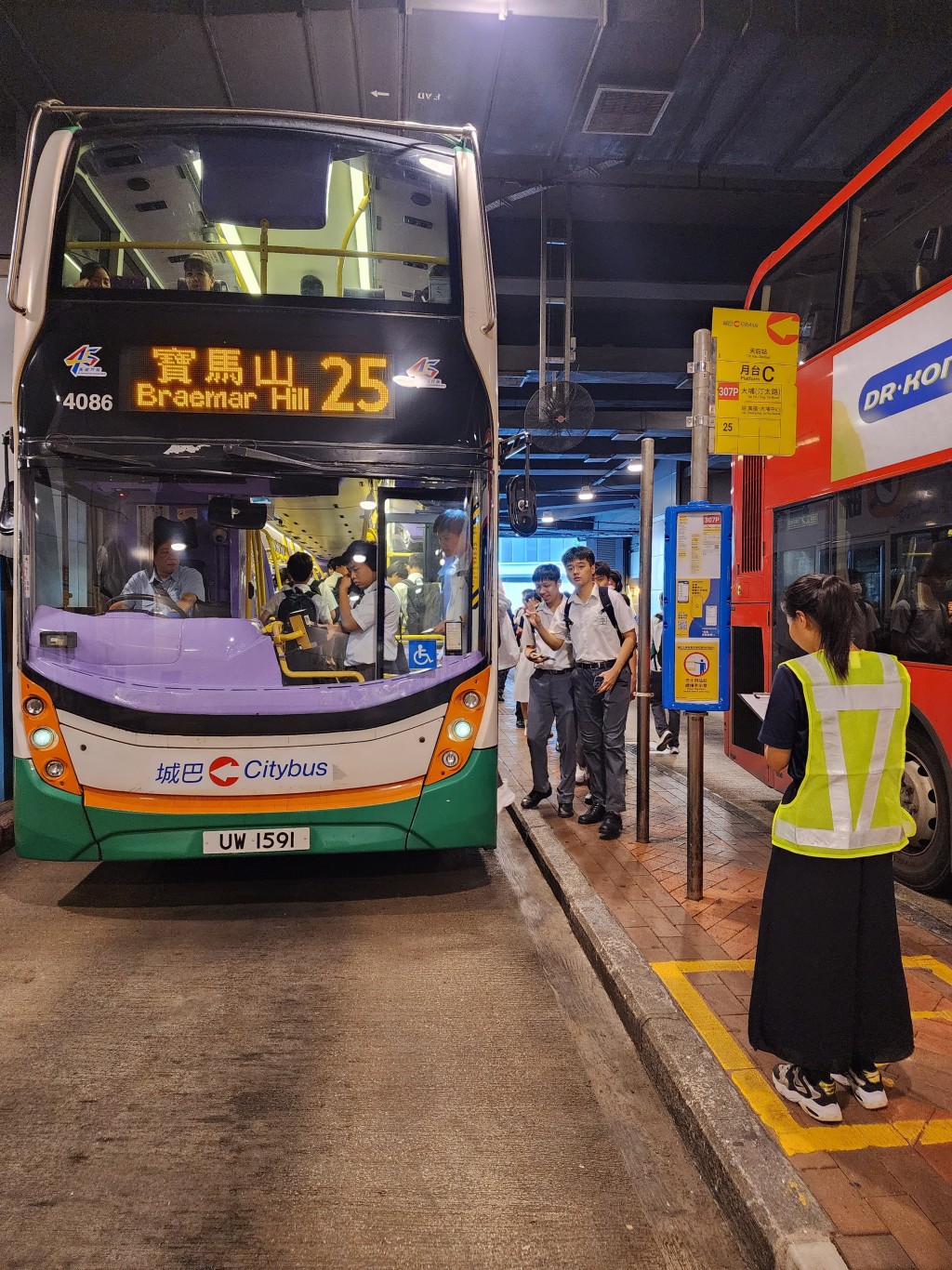 運輸署派出約110名人員，實地監察開學日港九新界主要公共運輸交匯處、鐵路站、學校區、口岸和隧道等交通情況，實時向緊急事故交通協調中心匯報。圖示人員（右一）在天后站公共運輸交匯處監察交通情況。（政府新聞處）