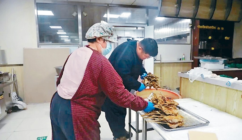 「鵝腿阿姨」陳秀鳳和丈夫梁德才在打包「鵝腿」。
