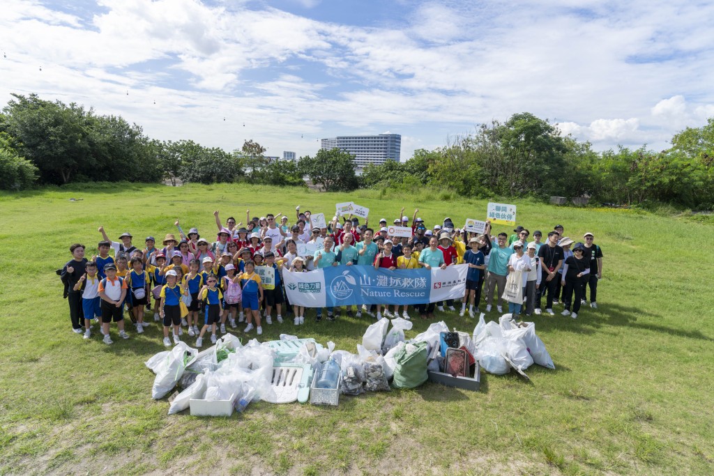是次大嶼山東涌灣大型清潔活動的參加者興奮地展示活動「成果」。