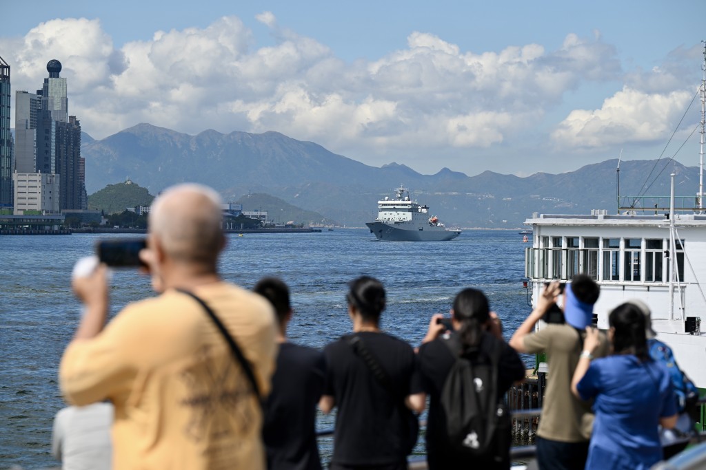 市民及遊客紛紛拍下兩艘軍艦駛離香港的情況。劉駿軒攝