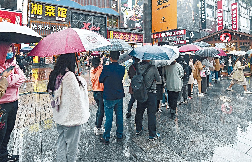 長沙一家奶茶店，數百年輕人冒雨排隊。