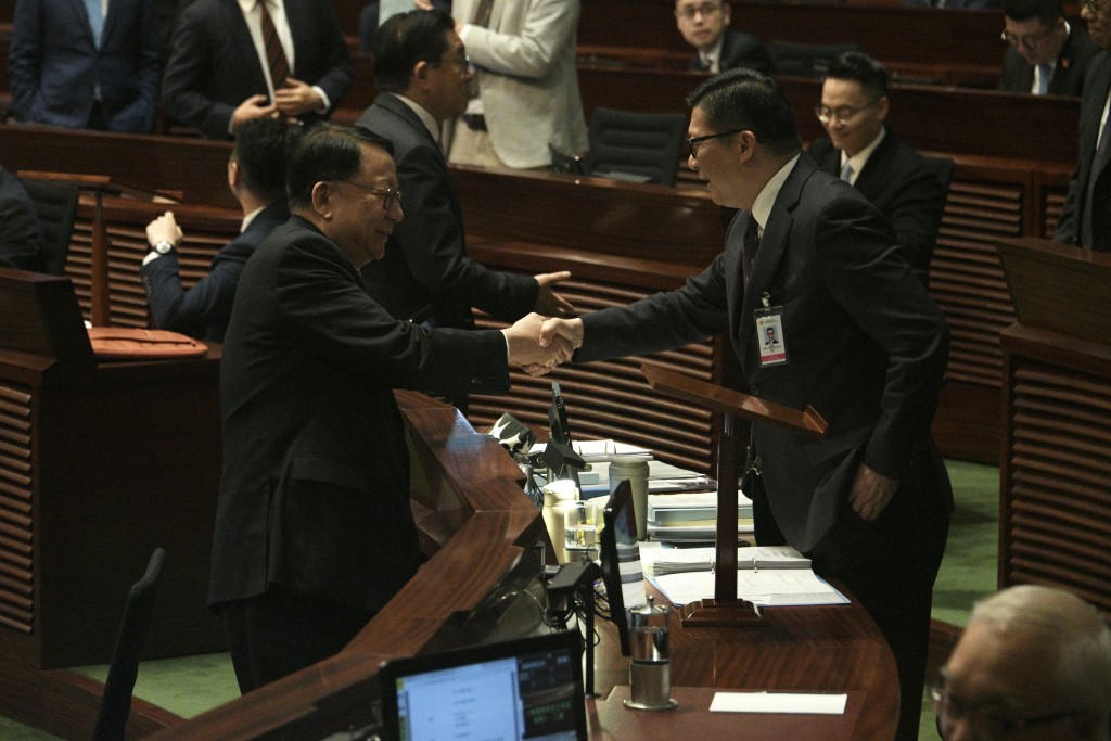 陈国基与邓炳强握手道贺。