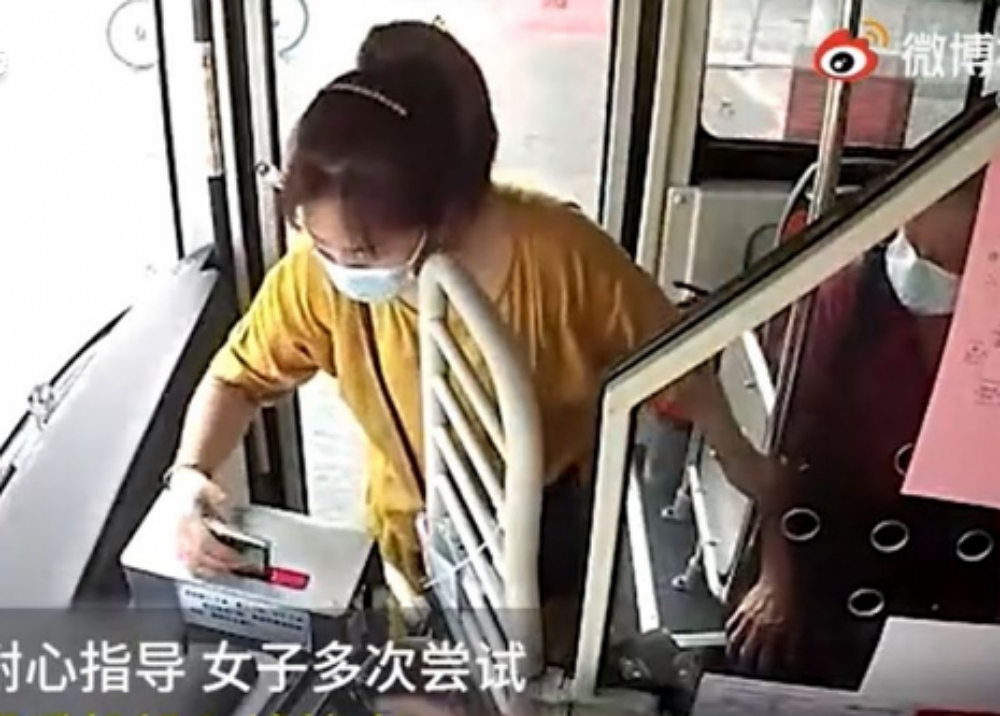 婦人竟將整部手機塞進錢箱中,司機想阻止也來不及。網圖