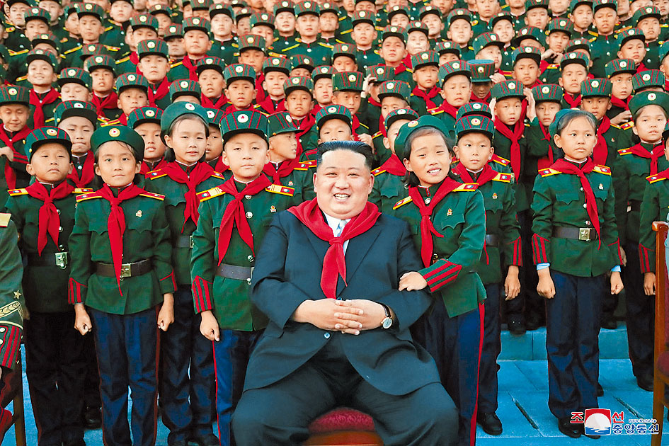 金正恩周三在平壤萬景台革命學院與學童合照。