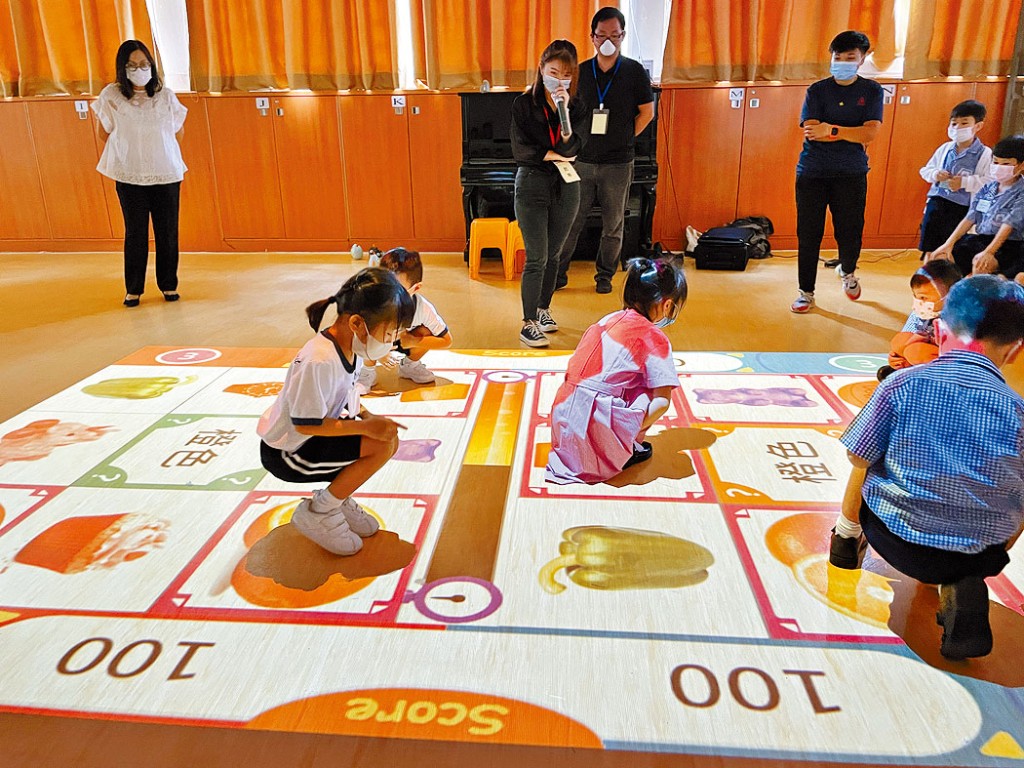 主風小學的小一學生在禮堂內,聽從教師指示參與活動,「尋找」題目需要的「物品」。