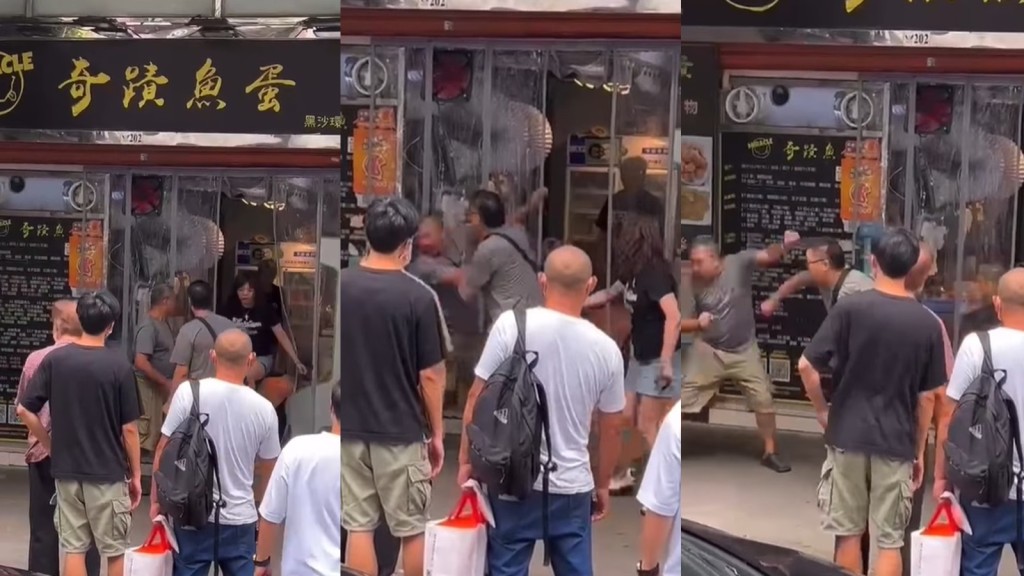兩名男子在一間食店外打鬥。網上片段截圖