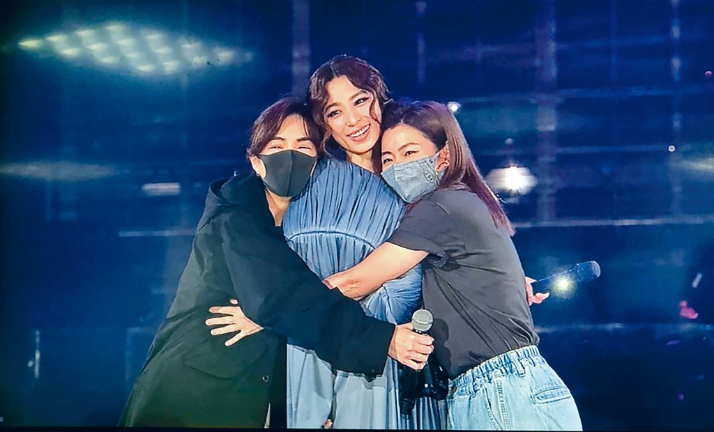 S.H.E在小巨蛋舞台上相擁。