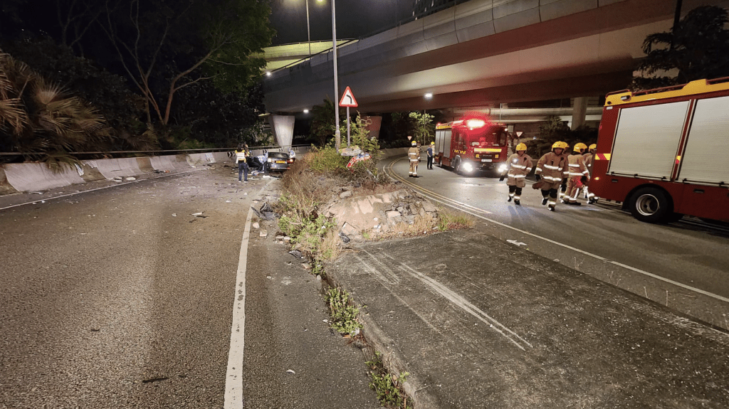 寶馬私家車鏟上中間分隔石壆，從這照片可見，路壆上的花槽和路牌均被撞毀。黎志偉攝