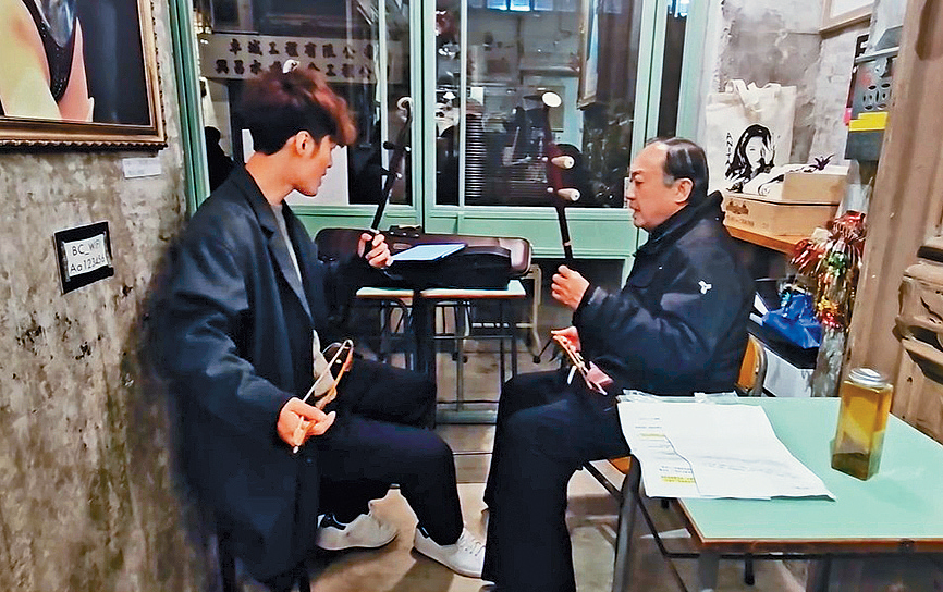 朱芸編教許冠文拉二胡，邊唱邊奏南音《遊十殿》。