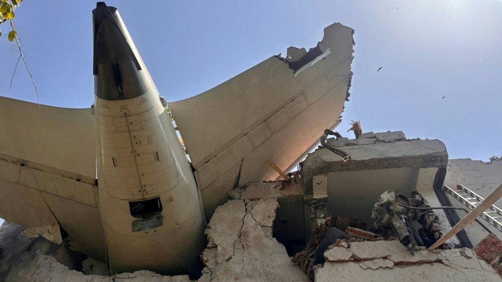 客機殘骸擱在建築物上露出機尾。路透社 客機殘骸擱在建築物上露出機尾。路透社