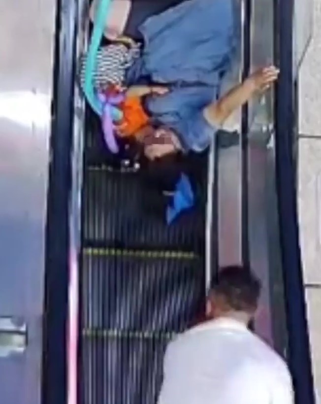 男子按掣把扶手电梯停下。网上截图