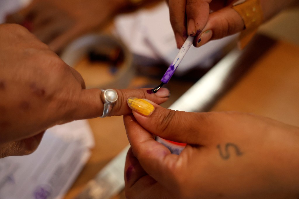 一名女子畫點墨作為已投票的證明。 路透社